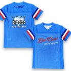 Two blue Men’s Sublimated Tee Shirts with red, white, and blue sleeve stripes and academy logos.