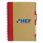 A brown spiral notebook with a red pen attached.
