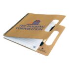 Spiral notebook with brown cover, pen, and The Housing Corporation logo on front.