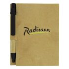 A brown notebook with the Radisson logo in black and green on the cover. A black and brown pen is attached to the left side of the notebook.