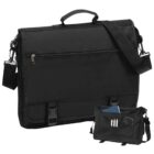 Black messenger bag with handle and strap, shown open with pens and a notebook inside.