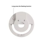 Circular device with button labeled Long press the flashing function.