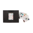 Black gift bag with a floral card and scattered colorful stickers.