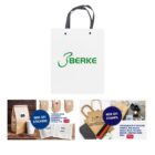 White paper bag with BERKE logo. Below, images of customizable bags with stickers and stamps.