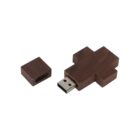 Wooden cross-shaped USB flash drive with detached cap on white background.