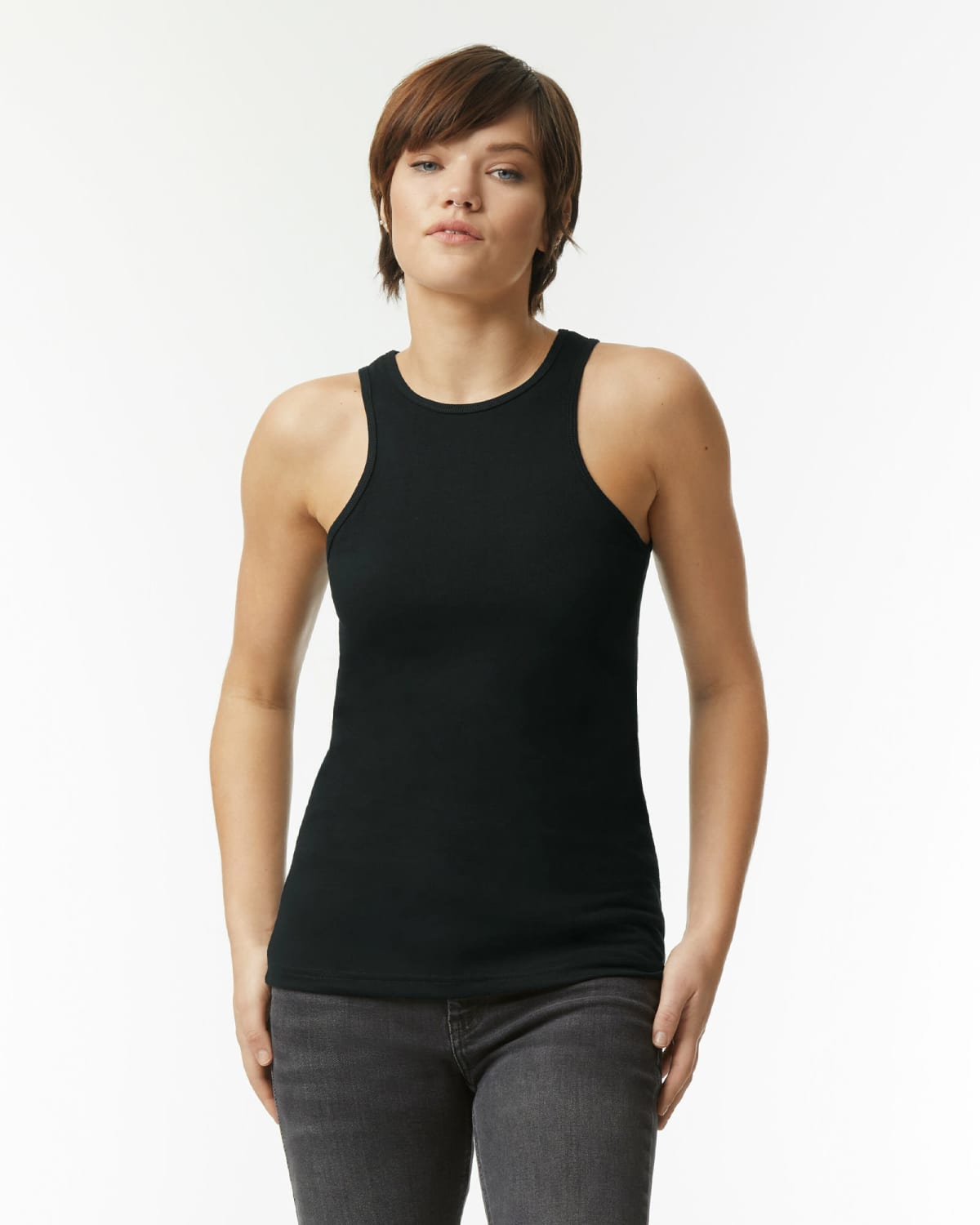 Person wearing a black sleeveless top and dark jeans, standing against a plain light background.