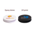 Two round phone grips: one white with Epoxy dome text, one black with UV print text.