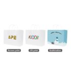 Three white bags with screen print, UV print, and sublimation designs displayed.