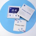 Privacy care kit with RFID blocking card and USB, on a blue and white surface.
