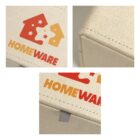 Close-up of a beige box with the HOMEWARE logo in red and yellow.