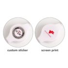 Two round white objects with custom logos; one logo is a sticker, the other is screen-printed.