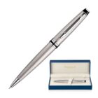 A sleek silver ballpoint pen with polished accents is displayed. Below it, a blue box with a white interior shows the pen resting inside. The box is labeled WATERMAN.