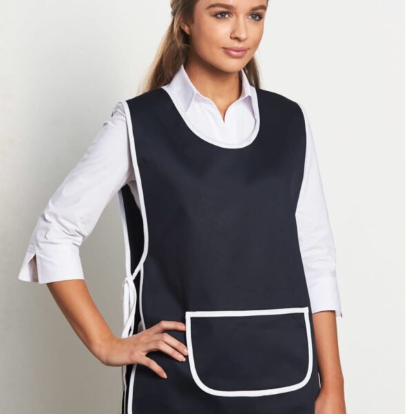 Person wearing a black apron with white trim and a large front pocket over a white shirt, standing against a plain background.