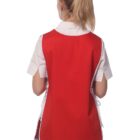 A person with blonde hair, in a ponytail, is wearing a red smock over a white shirt. The person is seen from the back and is also wearing black pants. The smock has white trim along the edges. The background is plain white.
