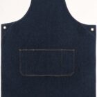 A dark blue denim apron with a large front pocket and reinforced corners with metal rivets. It has adjustable straps and orange stitching outlining the pocket and edges. The apron is laid flat against a plain white background.