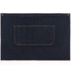 A rectangular denim mat with a central rectangular pocket featuring orange stitching is laid flat. The mat has two brass-colored buttons on the top corners, possibly for hanging or attachment. The denim is dark blue.