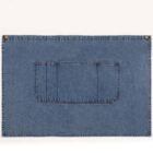 A rectangular blue denim mat with red stitching and a large pocket in the center. The mat has two metal grommets at the top corners for hanging or securing. The background is a plain off-white color.