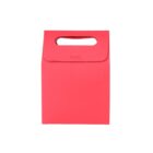 Red paper gift bag with a handle on a white background.
