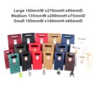 Colorful gift bags in three sizes with hanging ornaments.