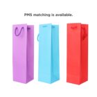 Three colorful gift bags in purple, blue, and red with handles; text above reads PMS matching.