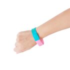 Hand wearing a blue and pink wristband, against a plain white background.