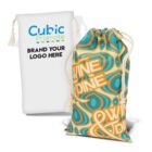 Two fabric bags with drawstrings. One is white with customizable branding text. The other is colorful with orange, teal, and green patterns and the words WINE & DINE in bold letters.