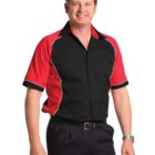 Smiling man in a red and black bowling shirt with short sleeves.