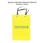 Yellow shopping bag with Ben Betesh text and black handles. Bag size details above.