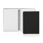 Two spiral-bound notebooks are shown. One is open, displaying lined pages with Date at the top. The other notebook is closed, featuring a plain black cover. Both are placed against a white background.