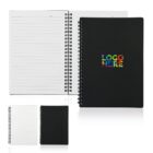 Three spiral-bound notebooks are displayed. The largest is open, showing lined pages, with a black cover and multicolored LOGO HERE text. Below, two smaller closed notebooks feature plain white and black covers.