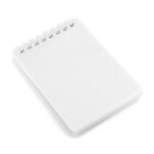 A blank white spiral notebook is placed on a white surface. The notebook is closed and positioned at a slight angle, with the spiral binding visible along the top edge.