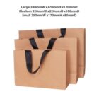 Three brown shopping bags with black handles in different sizes.