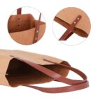 Brown paper bag with leather handles and metal rivets, showing close-up details of construction.