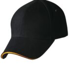 Black baseball cap with a curved brim and orange trim on a white background.