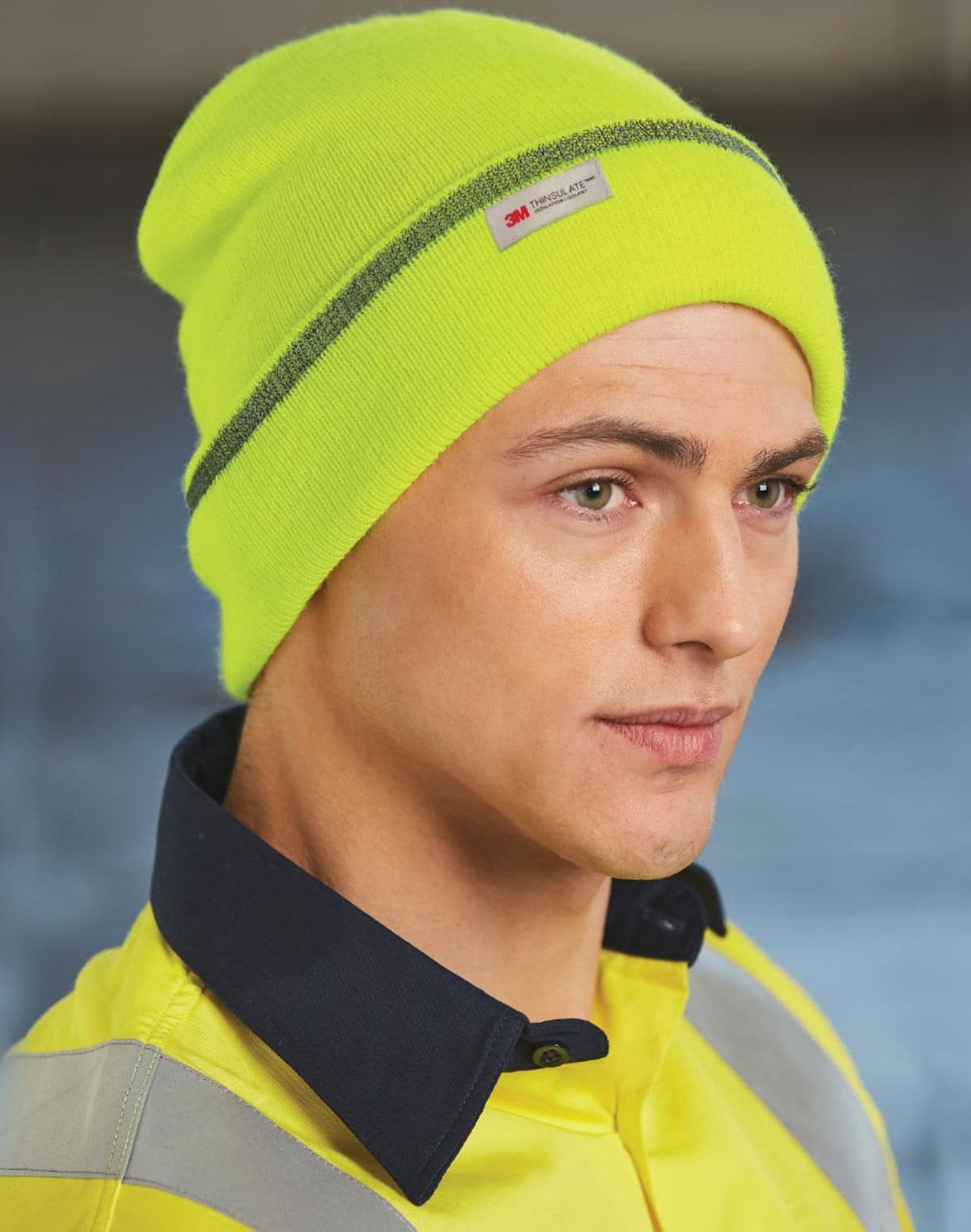 Person wearing a bright yellow beanie and matching high-visibility jacket.