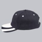 Black baseball cap with a white-striped bill, side view.