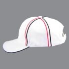 White baseball cap with red and black stripes, side view, on a gray background.