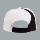 Back view of a white baseball cap with a black stripe and adjustable strap.