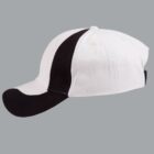 White and black baseball cap on a gray background, side view.