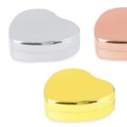 Three heart-shaped metal boxes in silver, rose gold, and gold with a vanilla logo on the left.