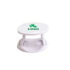 White round phone stand with a green logo on top.