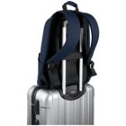 Navy backpack secured on top of a silver suitcase with an extended telescopic handle.