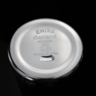 Silver metal lid with China darani recycled stainless steel and a recycle symbol engraved.