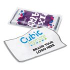 Two microfiber cleaning cloths are shown. One is folded in a clear plastic pouch with a purple design. The other is unfolded, featuring the text Cubic Promote and BRAND YOUR LOGO HERE in green and blue on a white background.