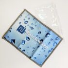 Blue microfiber cloth with water droplet design and Rockware Glass logo next to a clear plastic pouch on a white background.