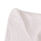 Close-up of the corner of a smooth, white fabric garment against a white background.