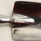 Metal spade with Extra HD engraved on the blade.