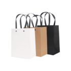 Three shopping bags: white, brown, and black, each with black handles, against a white background.