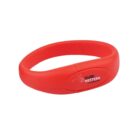 Red silicone wristband with a white logo and text.