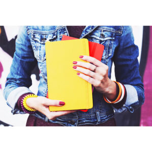 woman holding a promotional notebook